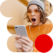 Joven con cara de sorpresa mientras ve algo en su teléfono móvil